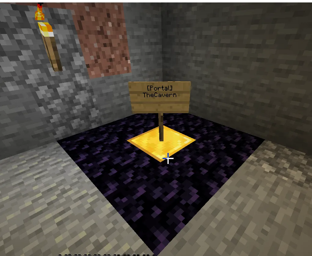 A Minecraft screenshot of a small obsidian portal in a stone cave, marked by a sign that reads '[Portal] TheCavern'.